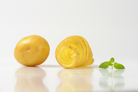 whole potato and spiral-cut potatoの写真素材