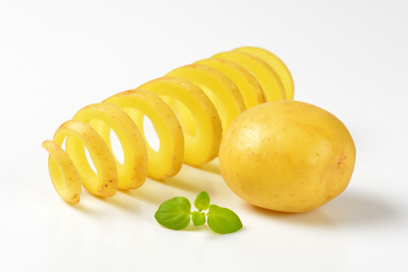 whole potato and spiral-cut potatoの写真素材