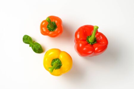 three ripe bell peppers on white backgroundの写真素材