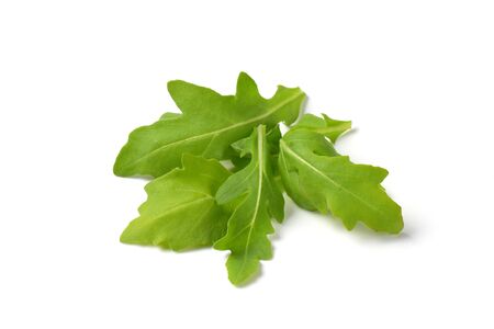 handful of fresh arugula leaves on white backgroundの写真素材