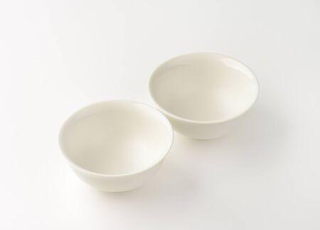 two empty deep white bowlsの写真素材