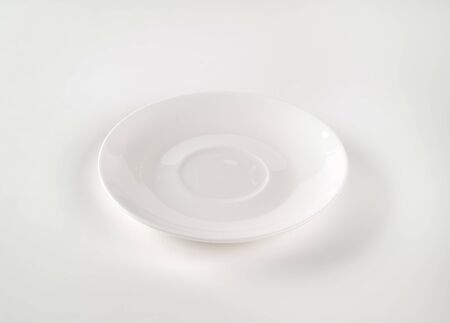 empty white saucer on white backgroundの写真素材