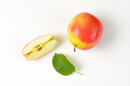 quarter of an apple next to a whole appleの写真素材