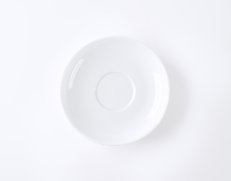 empty white saucer on white backgroundの写真素材