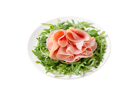 Sliced ham on nest of rocket saladの写真素材