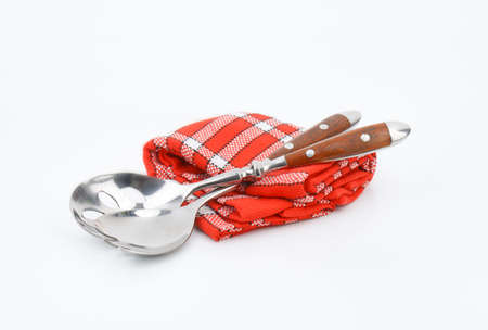 salad servers on red dishtowelの写真素材