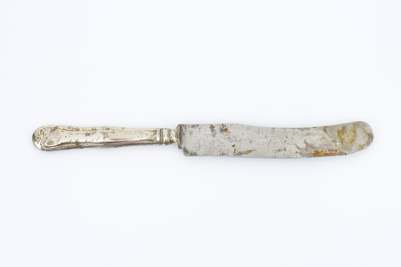 rusty old table knife on white backgroundの写真素材