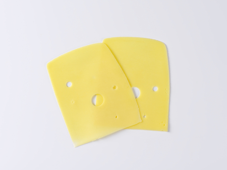 two slices of medium-hard emmental cheeseの写真素材