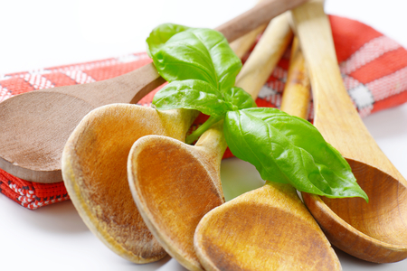 group of wooden spoons on red dish towelの写真素材