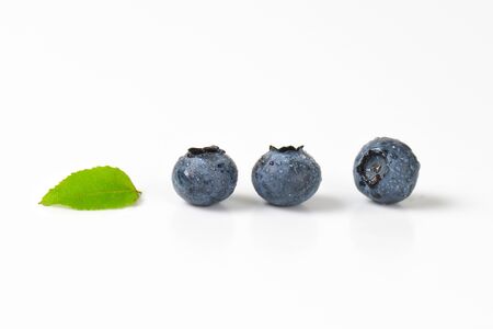Three fresh blueberries on white backgroundの写真素材