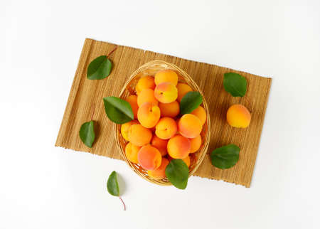 Fresh apricots in basket bowlの写真素材