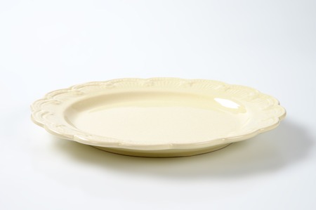 beige plate with embossed rimの写真素材