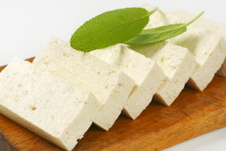 Slices of fresh tofu on cutting boardの写真素材