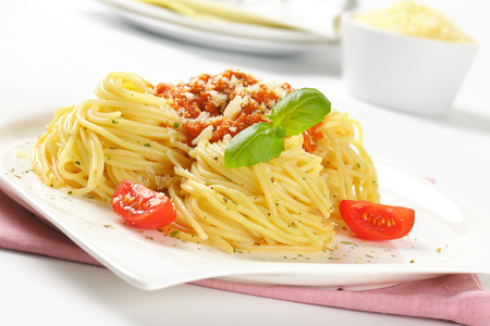 spaghetti with tomato pesto sprinkled with parmesan cheeseの写真素材