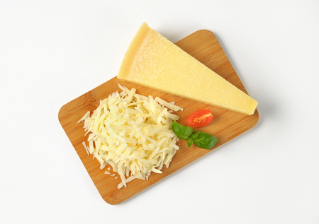 grated parmesan cheese on wooden cutting boardの写真素材