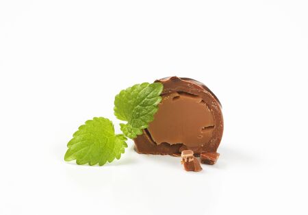half a belgian chocolate praline on white backgroundの写真素材