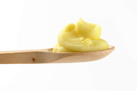swirl of potato puree on wooden spoonの写真素材