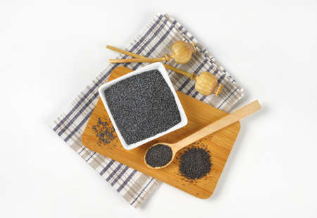 ripe poppy seeds - whole and ground on cutting boardの写真素材