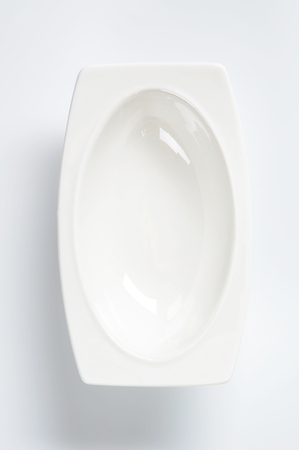 Deep oval plate with wide rectangular rimの写真素材