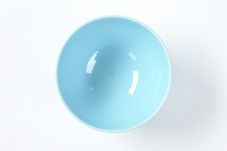 empty blue bowl on white backgroundの写真素材