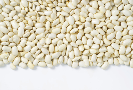 raw white beans on white background