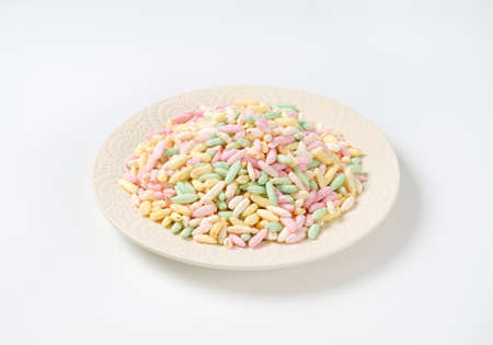 heap of colored puffed rice on plateの写真素材