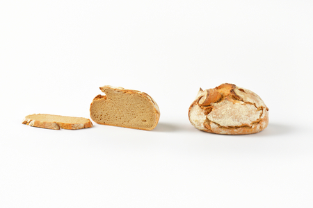 fresh crusty bread - whole loaf, half a loaf and sliceの写真素材