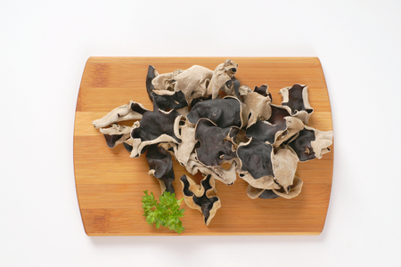 Air dried wood ear mushrooms on cutting boardの写真素材