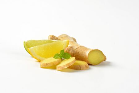 sliced ginger with lemon and lime on white background
