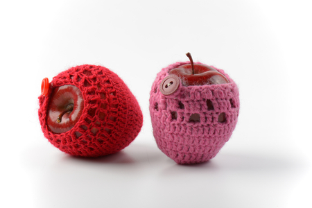 two red apples in crochet coziesの写真素材