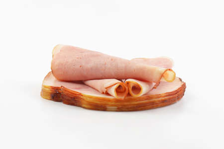 stack of ham slices arranged on white backgroundの写真素材