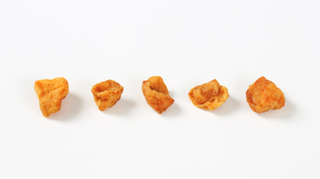 five pork greaves in a row on white backgroundの写真素材