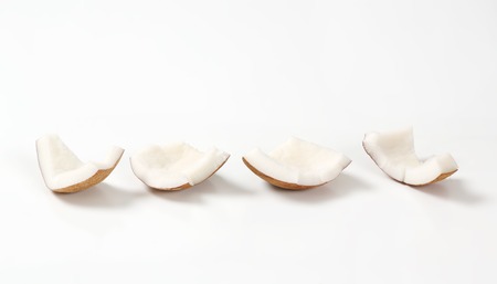 pieces of peeled coconut on white backgroundの写真素材