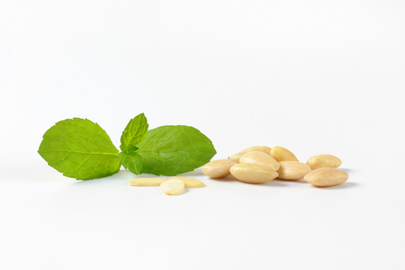 handful of skinless almonds on white backgroundの写真素材
