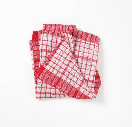 red and white checkered dish towel on white backgroundの写真素材