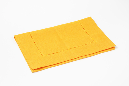 yellow cloth place mat on white backgroundの写真素材