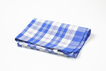 blue and white checkered dish towel on white backgroundの写真素材