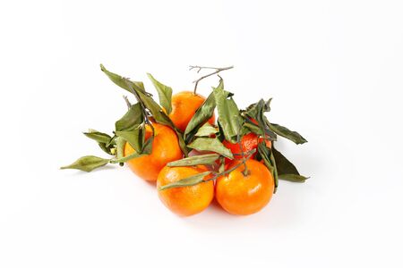 fresh tangerines with leaves on white backgroundの写真素材