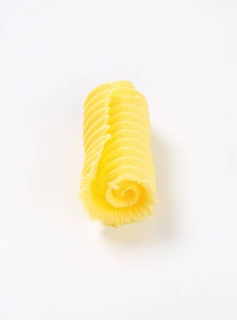 Curl of fresh butter on white backgroundの写真素材