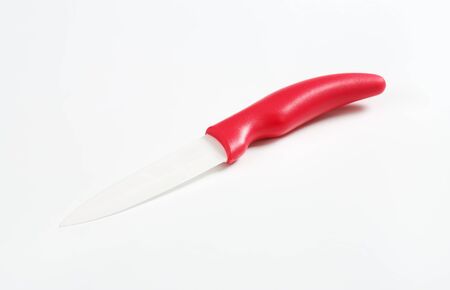 ceramic kitchen knife with white blade and red handleの写真素材