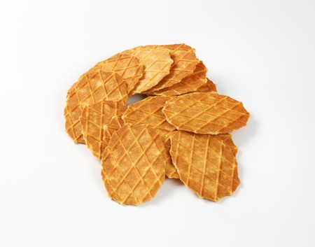 heap of butter waffle cookies on white backgroundの写真素材