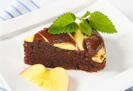 slice of chocolate cake with cream cheese on white square plate - close upの写真素材
