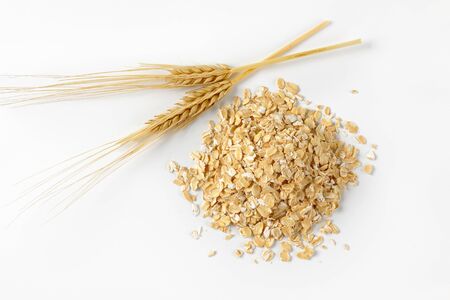 pile of oat flakes on white backgroundの写真素材