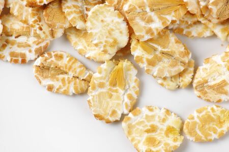 detail of oat flakes on white backgroundの写真素材