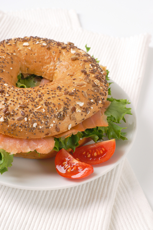 bagel sandwich with smoked salmon on white plate