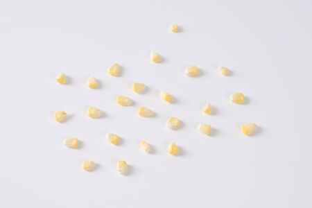 raw sweet corn kernels on white backgroundの写真素材