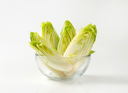 fresh Belgian endive halves in glass bowl