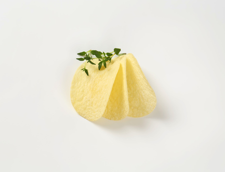 potato chips and thyme on white backgroundの写真素材