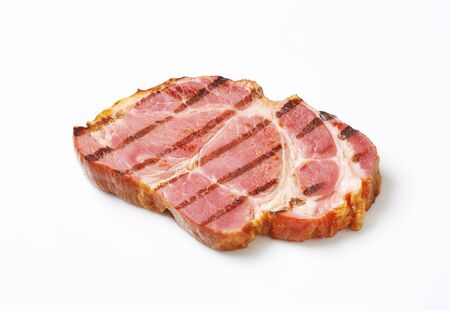 Grilled slice of smoked pork neck on white backgroundの写真素材