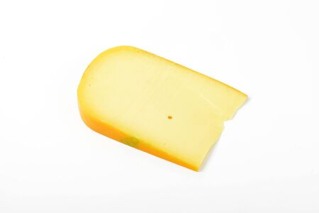 slice of gouda cheese on white backgroundの写真素材